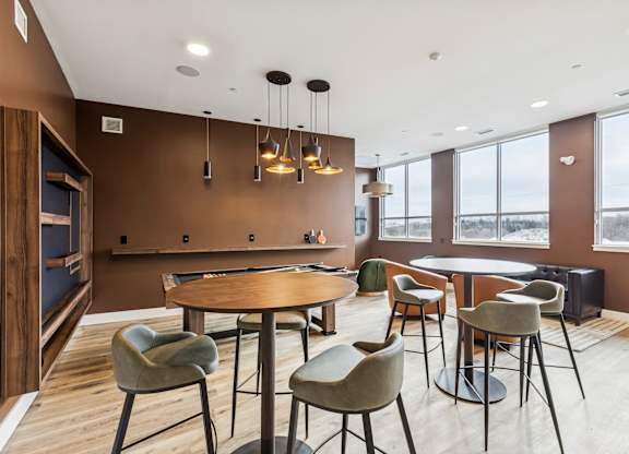 A modern dining room with a round table and chairs.
