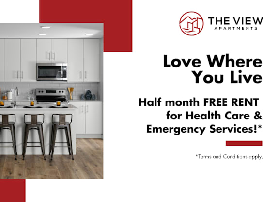 A modern kitchen with a red and white advertisement for The View Apartments offering half month free rent for health care and emergency services.