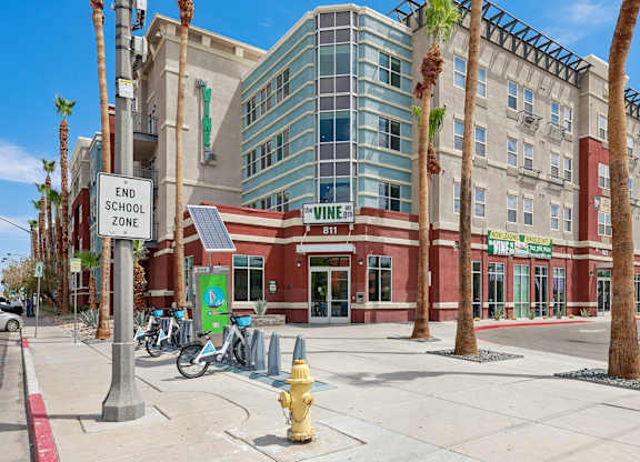 A street view of a building with a sign that says "END SCHOOL ZONE".