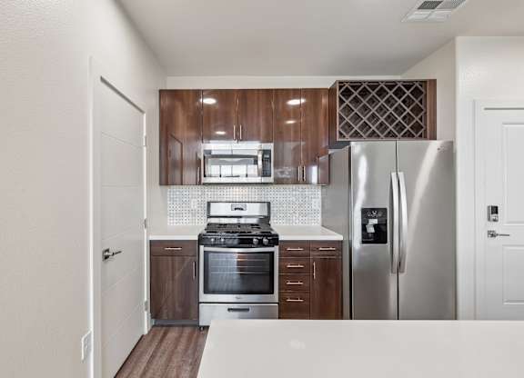 A kitchen with a stove, oven, and refrigerator.