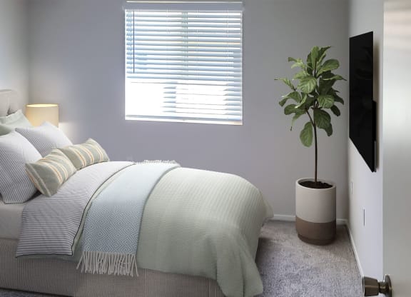a bedroom with a bed and a window at Silver Creek Apartments, Las Vegas, Nevada