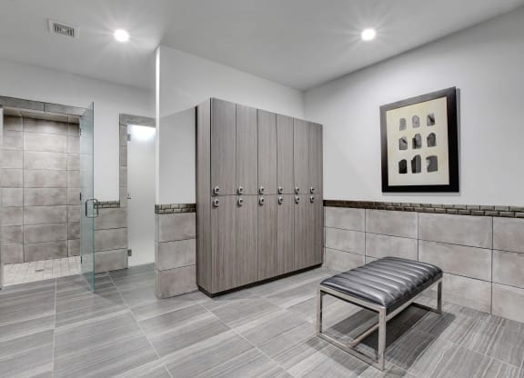 locker room with lockers and a bench at Evoq Apartment Homes, Las Vegas, NV 89169  