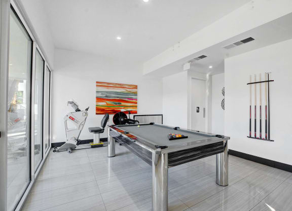 a games room with a ping pong table and a treadmill at Evoq Apartment Homes, Las Vegas, NV 89169  