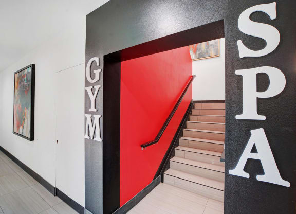 the stairway in the lobby of a building with a red door at Evoq Apartment Homes, Nevada  