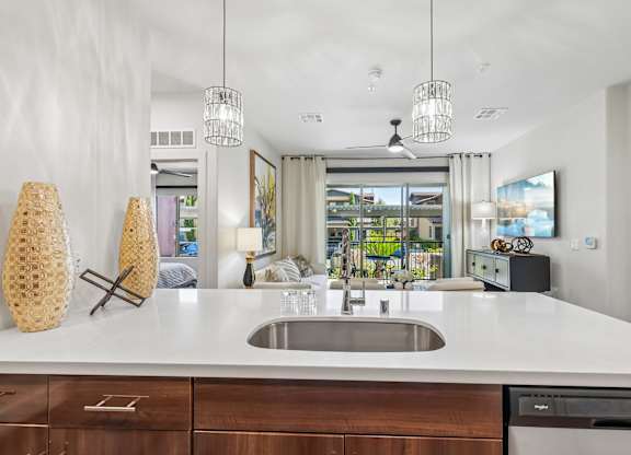 A modern kitchen with a large island and a dishwasher.