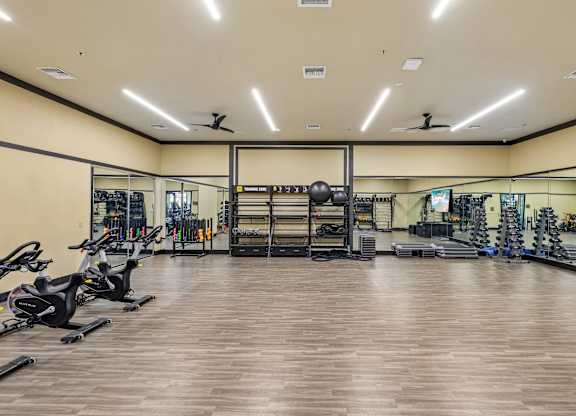 A spacious gym with a variety of exercise equipment.