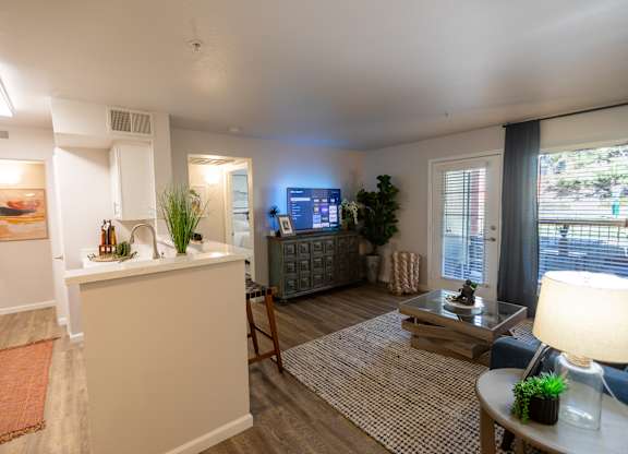 A living room with a white sofa and a wooden coffee table.
