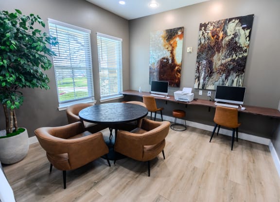 a conference room with two computers and chairs and a table at Austin Crest Apartments, Reno, NV