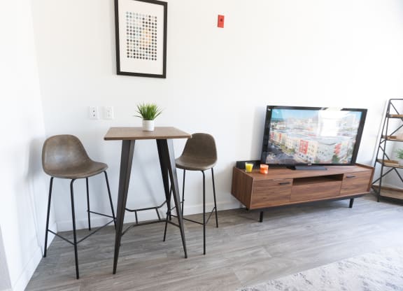 a living room with two stools and a table and a tv at ParcOne60, Nevada, 89501