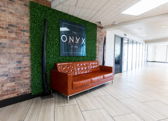a living wall in an office lobby with a brown couch at The Onyx at 695, Reno, NV, 89503