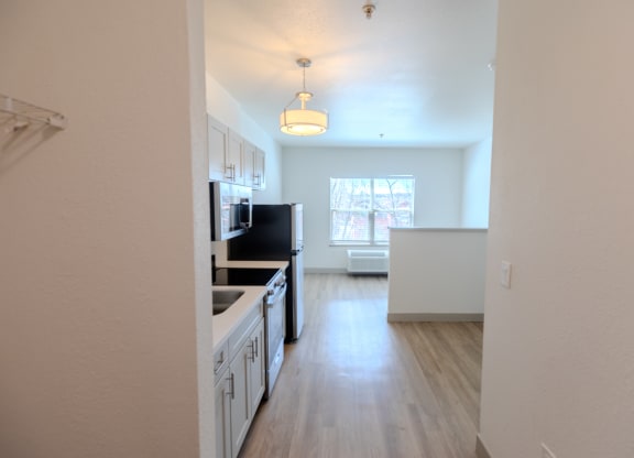 a kitchen and living room in an empty apartment at The Onyx at 695, Reno, NV
