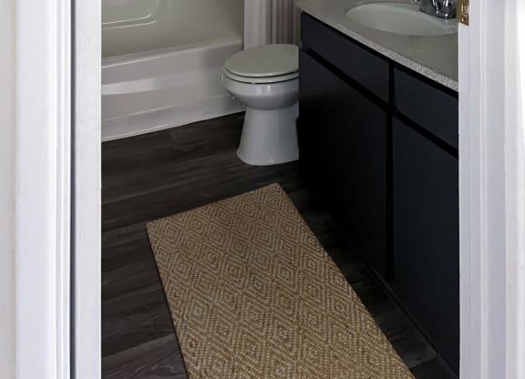 a bathroom with a sink and a toilet and a bath tub at Evoq Apartment Homes, Las Vegas, NV  