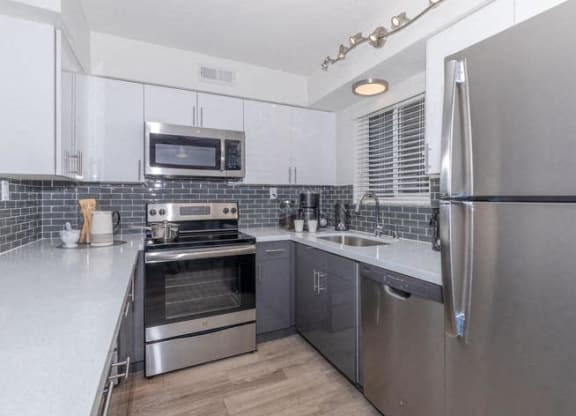 a kitchen with stainless steel appliances and a refrigerator at Evoq Apartment Homes, Nevada  