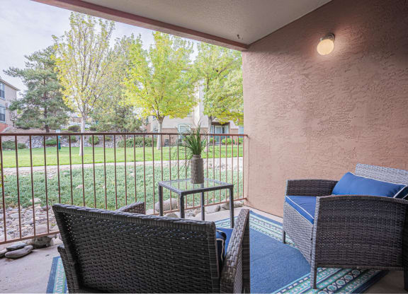 a patio with chairs and a table on a balcony at Austin Crest Apartments, Reno, NV, 89523