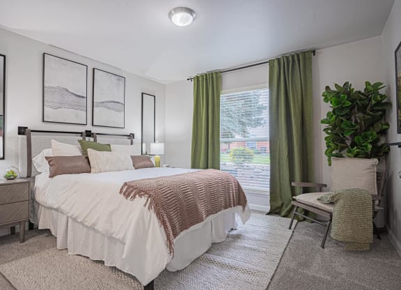 a bedroom with a large bed and a window at Austin Crest Apartments, Reno, 89523