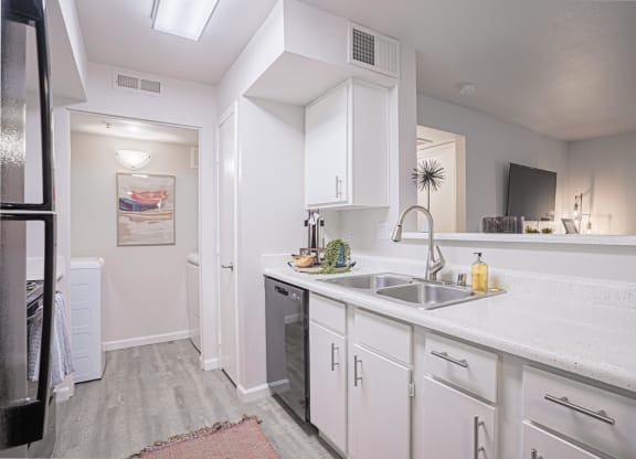 a kitchen with white cabinets and a stainless steel sink at Austin Crest Apartments, Nevada