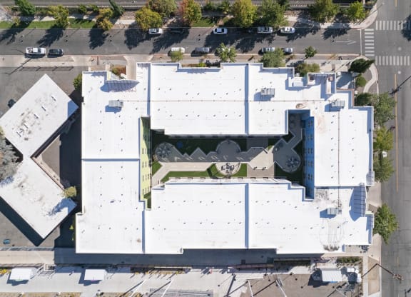 an aerial view of the roof of a white building with a green roof at The Onyx at 695, Reno, NV, 89503