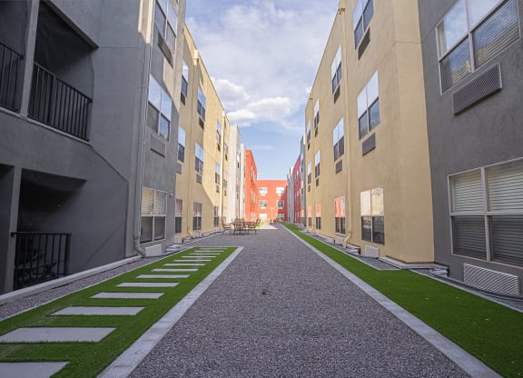 a view of a courtyard between two apartment buildings with grass at ParcOne60, Reno, Nevada