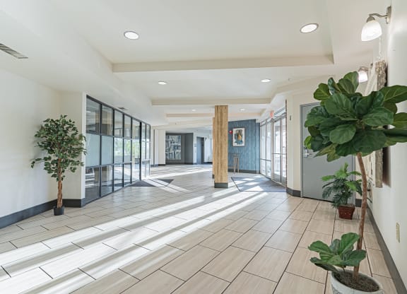 the lobby of a building with potted plants and glass doors at ParcOne60, Reno, 89501