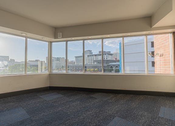 an empty living room with large windows and a city view at ParcOne60, Nevada, 89501