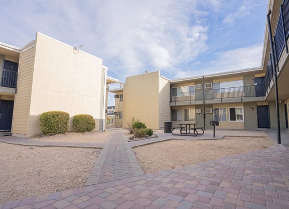 a courtyard between two apartment buildings with a picnic table at Regency Park, Nevada, 89509