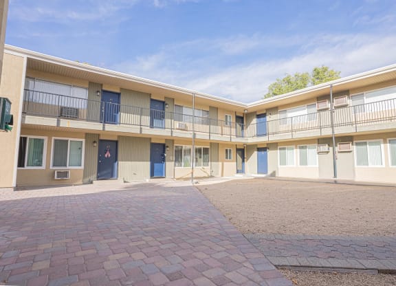 the courtyard of an apartment building with a brick courtyard at Regency Park, Nevada