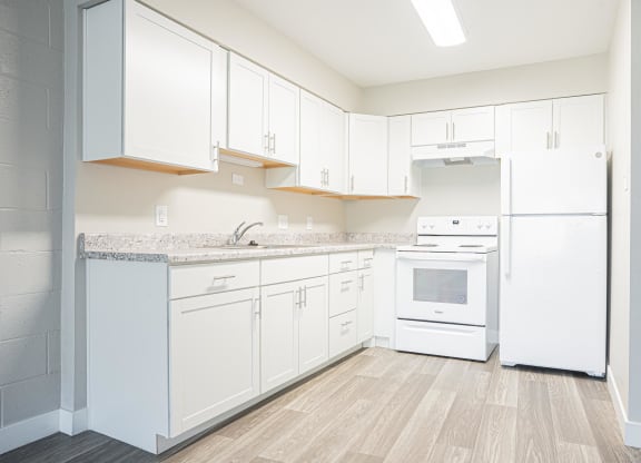 a white kitchen with white appliances and white cabinets at Regency Park, Reno, NV