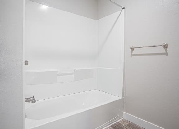 a white bathroom with a tub and a shower curtain at Regency Park, Reno, Nevada