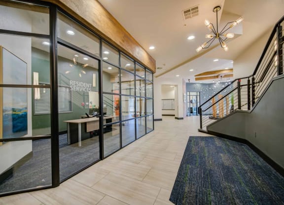 a large lobby with glass doors and a staircase at The Vine on 8th, Las Vegas, NV, 89101