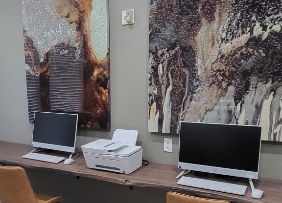 a desk with two laptops and a printer on it at Austin Crest Apartments, Reno, NV, 89523