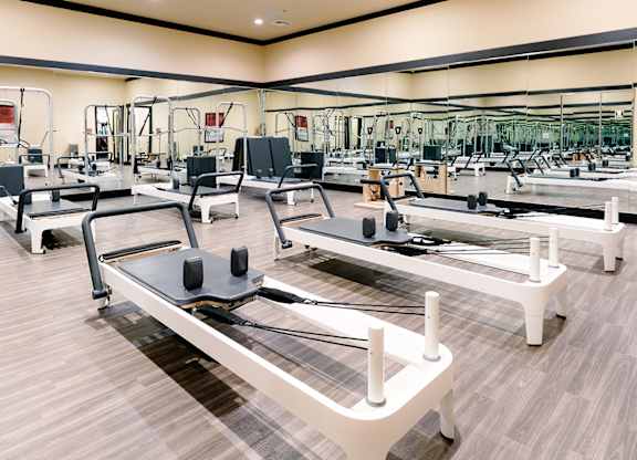 A gym with treadmills and other exercise equipment.