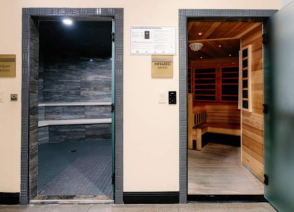 A room with a doorway leading to a room with a wooden floor and a sign that says "The Fearless Salon".