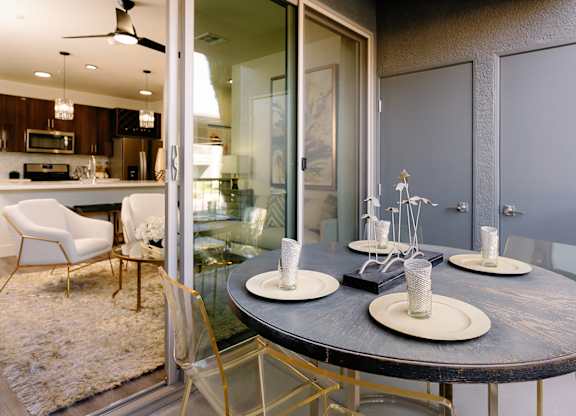 A modern dining room with a round table and chairs.