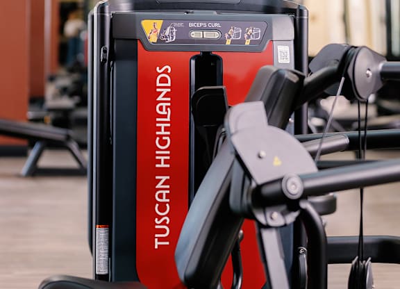 A Tuscany Highlands exercise bike is on a wooden floor.
