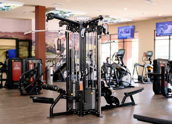 A gym with a variety of equipment including a leg press machine.