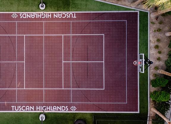 An aerial view of a tennis court with the name "Tuscan Highlands" written on it.