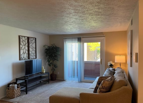 a living room with a couch and a tv at Monroeville Apartments, Monroeville, PA