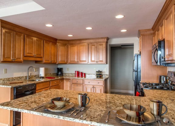 a kitchen with wooden cabinets and granite countertops at Monroeville Apartments, Monroeville, 15146