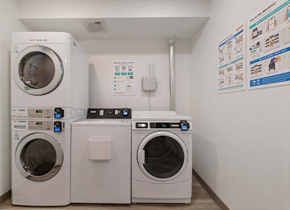 A white washing machine and dryer in a laundry room.