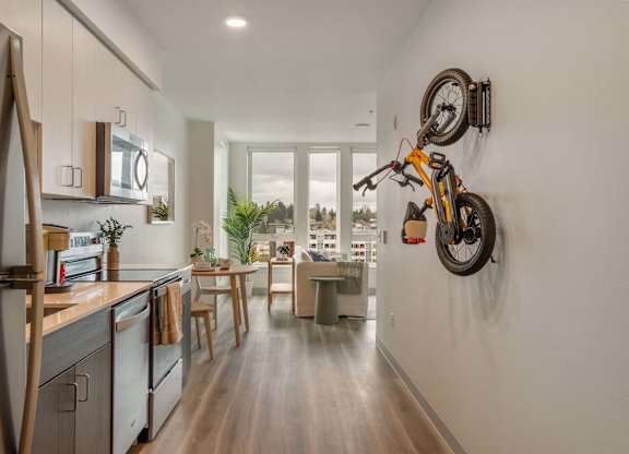 A modern kitchen with a bicycle mounted on the wall at Nook at Northaven Apartments, Seattle, WA