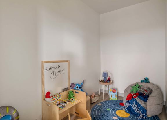 A child's playroom with a whiteboard at Nook at Northaven Apartments, Seattle, WA