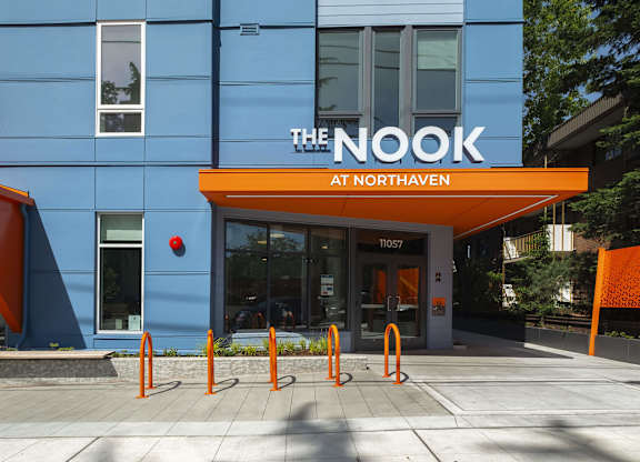 The Nook at Northaven is a blue building with orange accents.