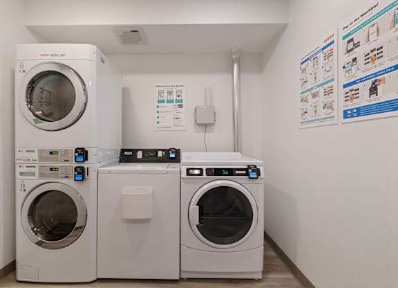 A white washing machine and dryer in a laundry room.
