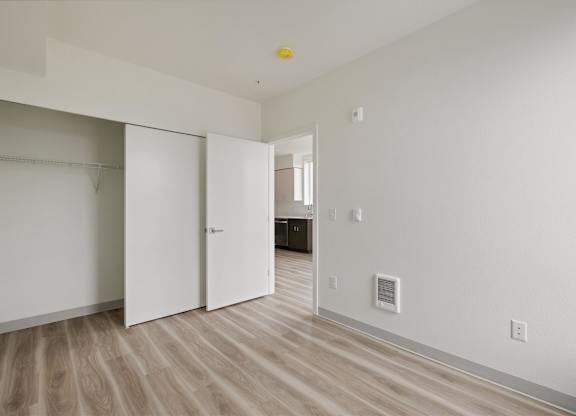A room with a white wall and a white closet with a white door at Nook at Northaven Apartments, Seattle, 98125