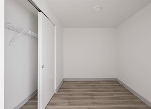A room with a white door and a wooden floor at Nook at Northaven Apartments, Seattle, 98125