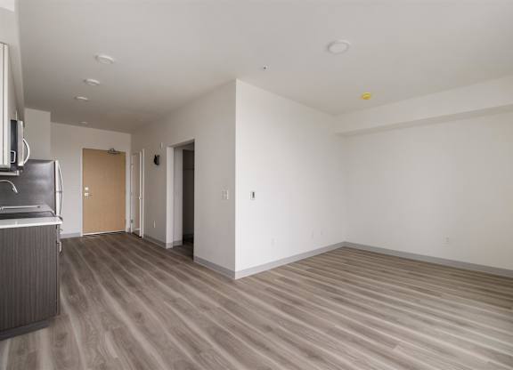 A room with a wooden floor and white walls at Nook at Northaven Apartments, Seattle, Washington