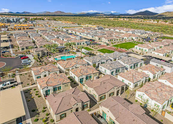 an aerial view of a neighborhood of houses and cars