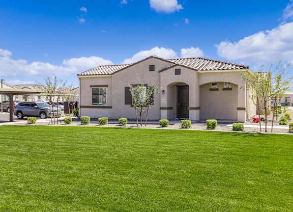 a house with a green lawn in front of it