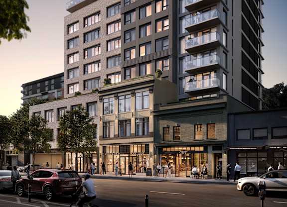 A modern apartment building is depicted with a street view showing cars, a cyclist, and pedestrians.
