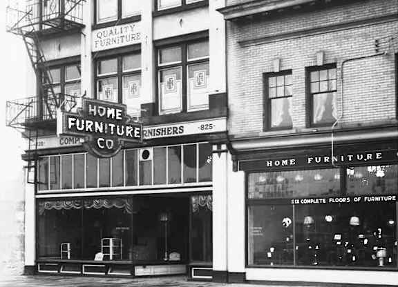 A black and white photo of a Home Furniture store.